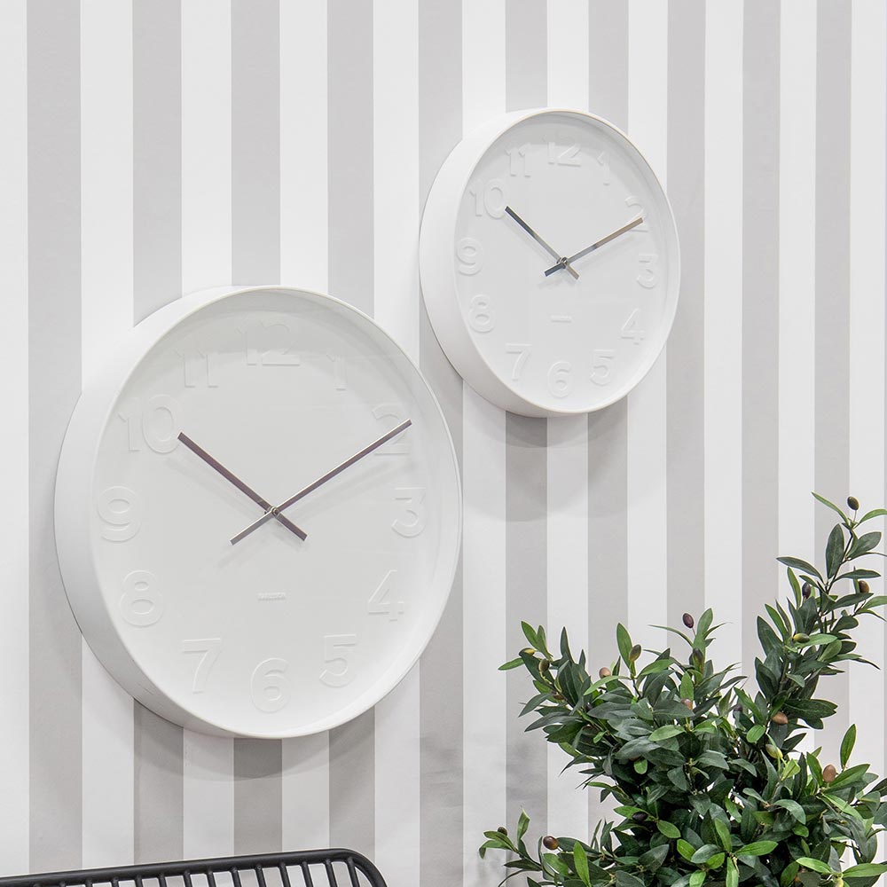 2x Karlsson Mr White Wall Clocks hanging on a grey striped wall at MyHouse