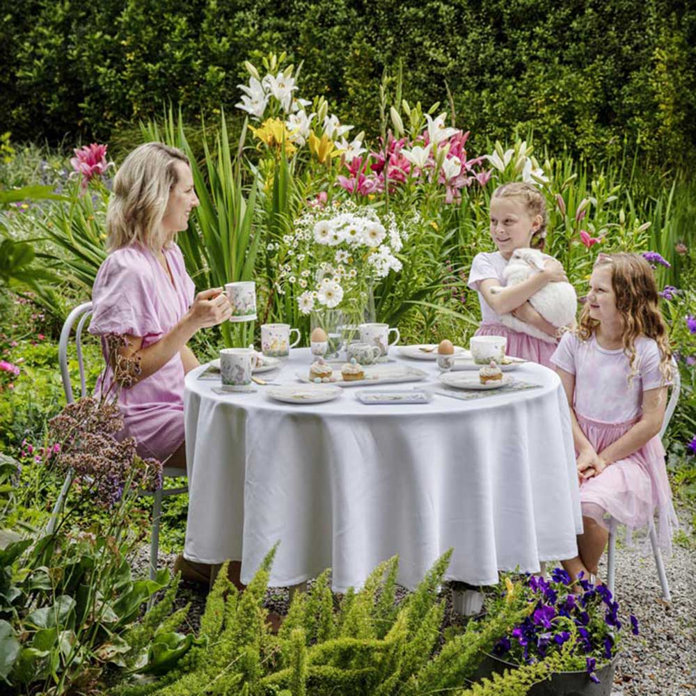 Family around the dining table outside -Ashdene Sweet Meadows Collection at MyHouse