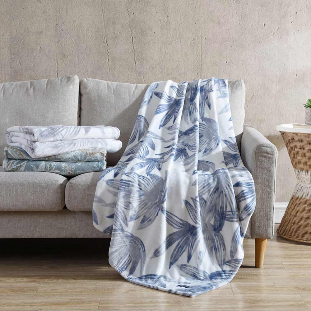 Tommy Bahama Tiki Bay Blanket Blue folded on the couch at MyHouse