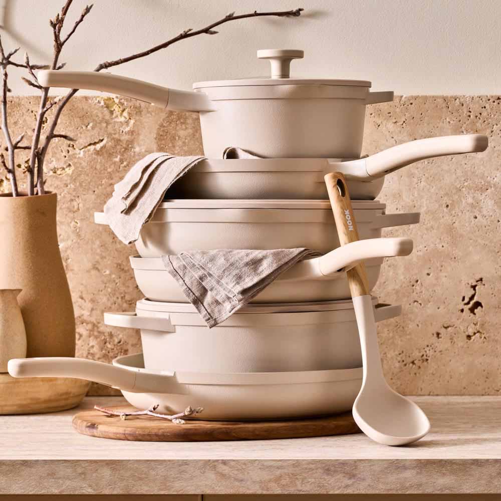 stack of cream cookware on stone kitchen counter