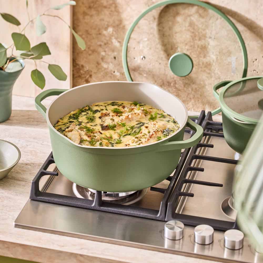 fish stew in a green casserole pot with lid