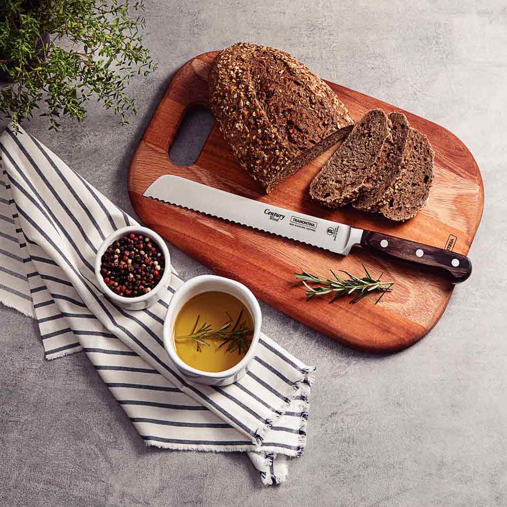 loaf of bread on a chopping board with slices of bread and a bread knife - MyHouse