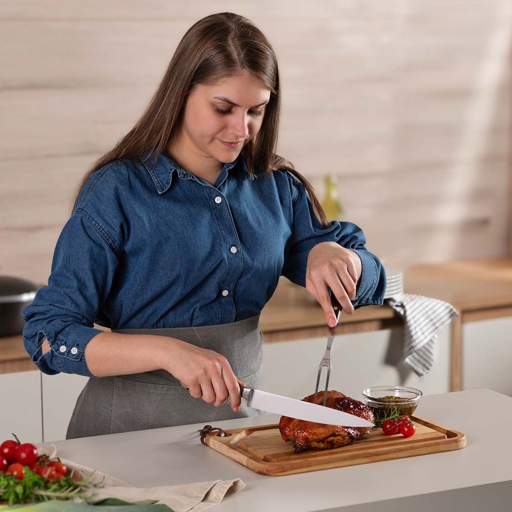 woman carving roast at kitchen bench with Utility Carving Knife - MyHouse