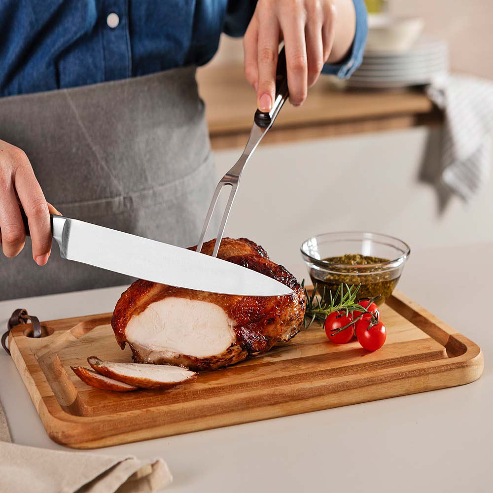 woman carving roast at kitchen bench with Utility Carving Knife - MyHouse