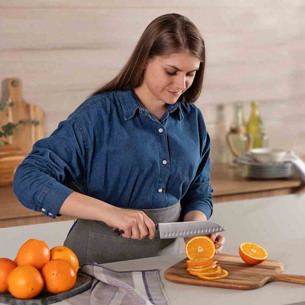 Woman slicing an orange with Santoku Knife 7 Inch - MyHouse