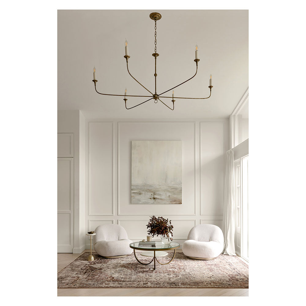 Darren Palmer Heirloom Rug in Plum in lounge room setting with large chandelier at MyHouse