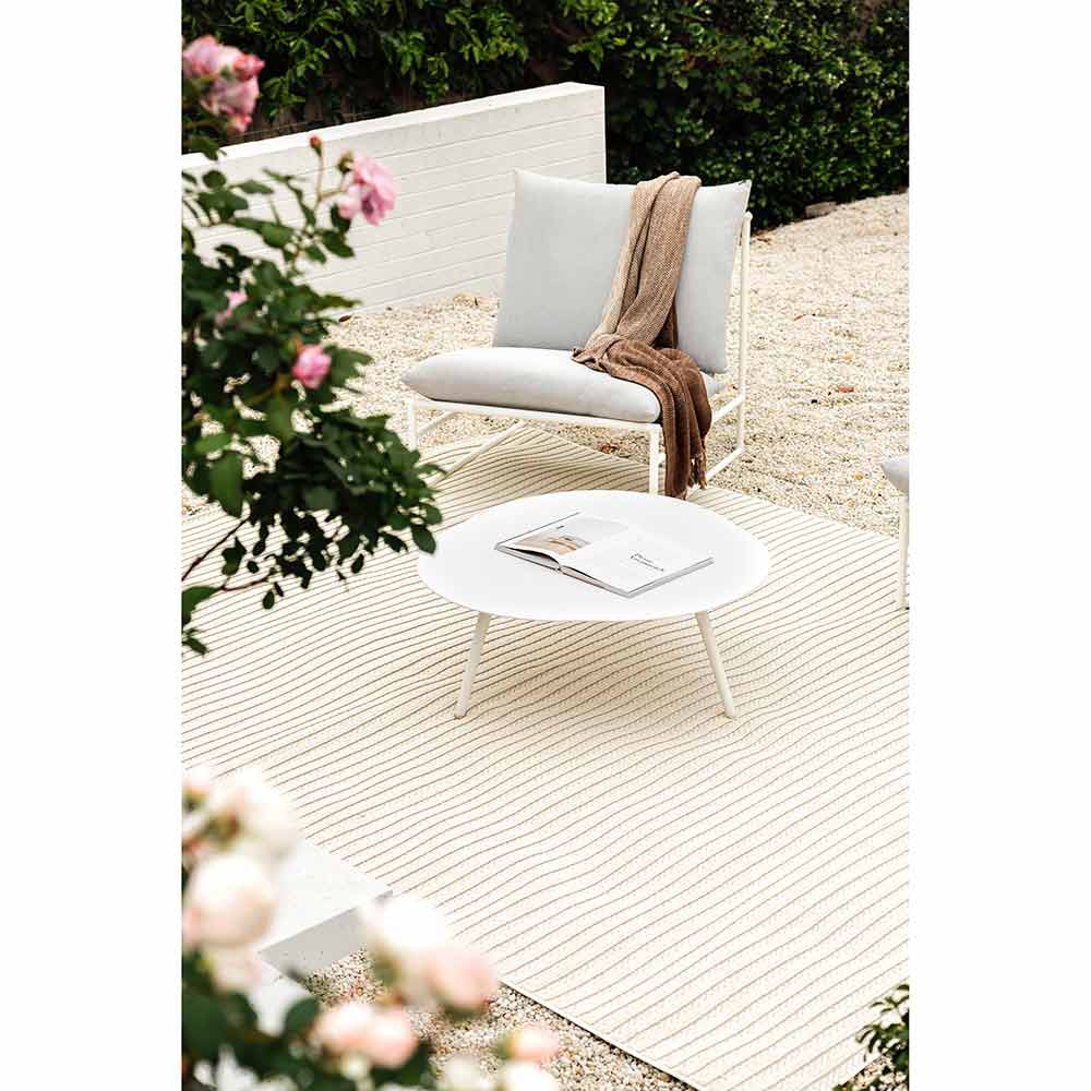 Darren Palmer Sandridge Indoor/Outdoor Rug in Cream outdoor setting on gravel path at MyHouse