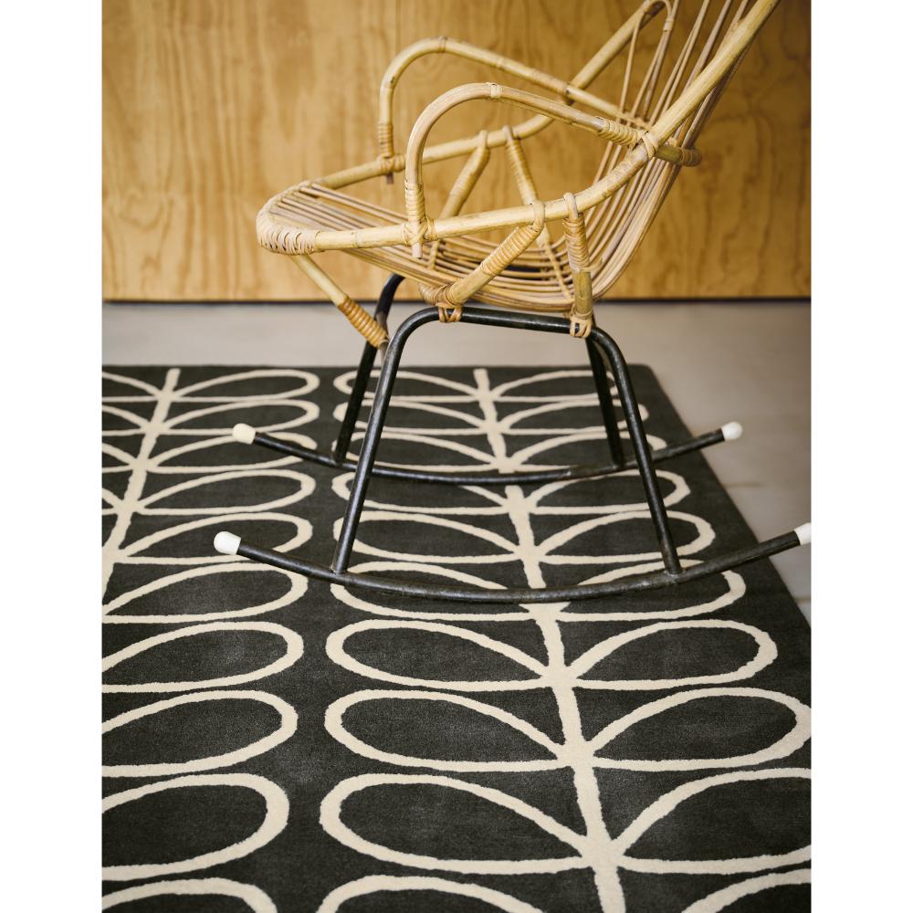 Grey Flower Stem Wool Rug with wicker rocking chair - MyHouse