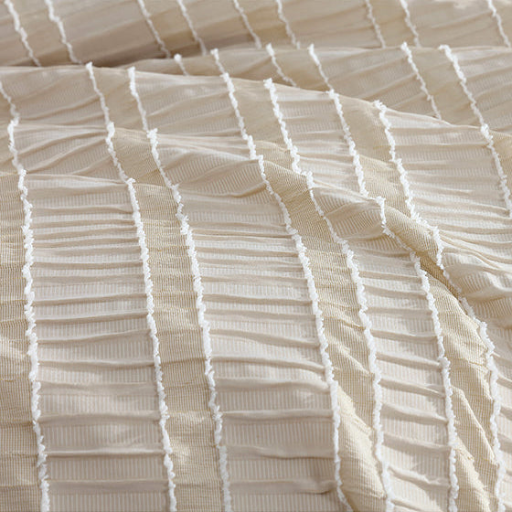 Close-up of textured beige fabric with horizontal lines on a white background