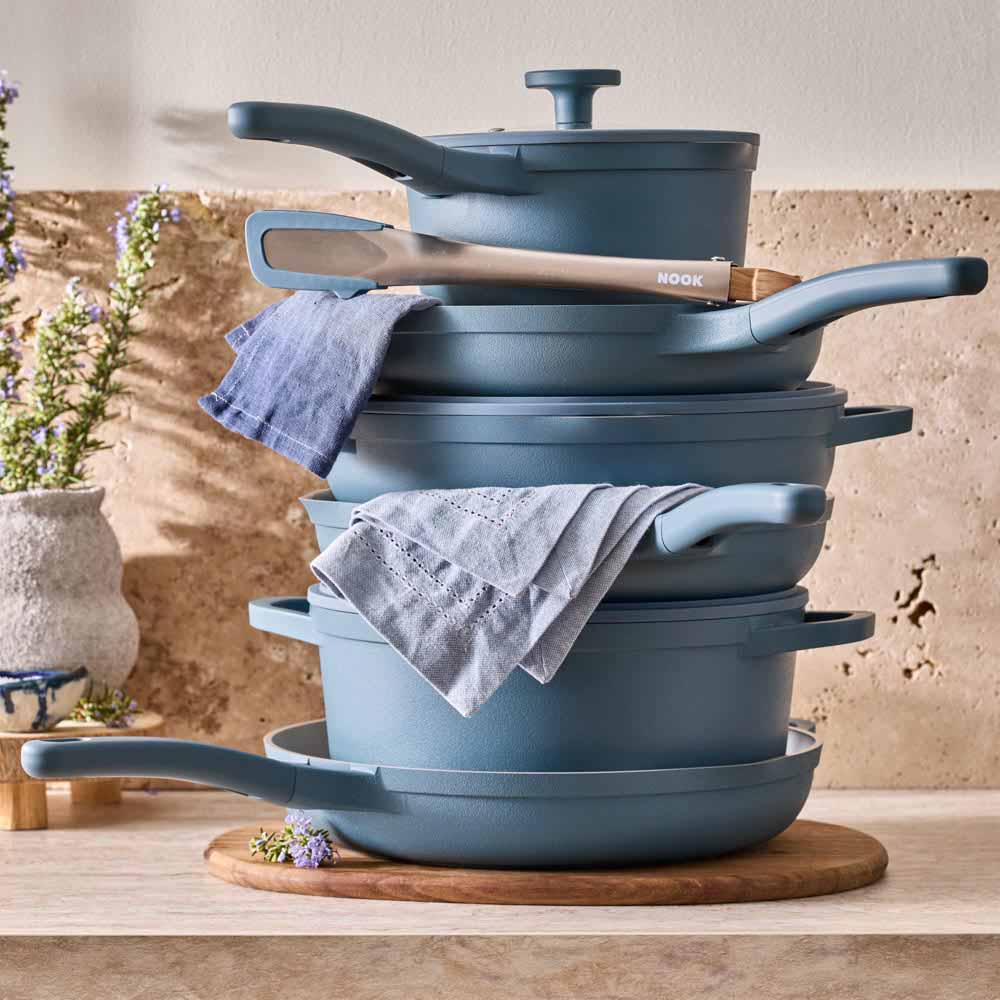 stack of blue cookware on stone kitchen counter