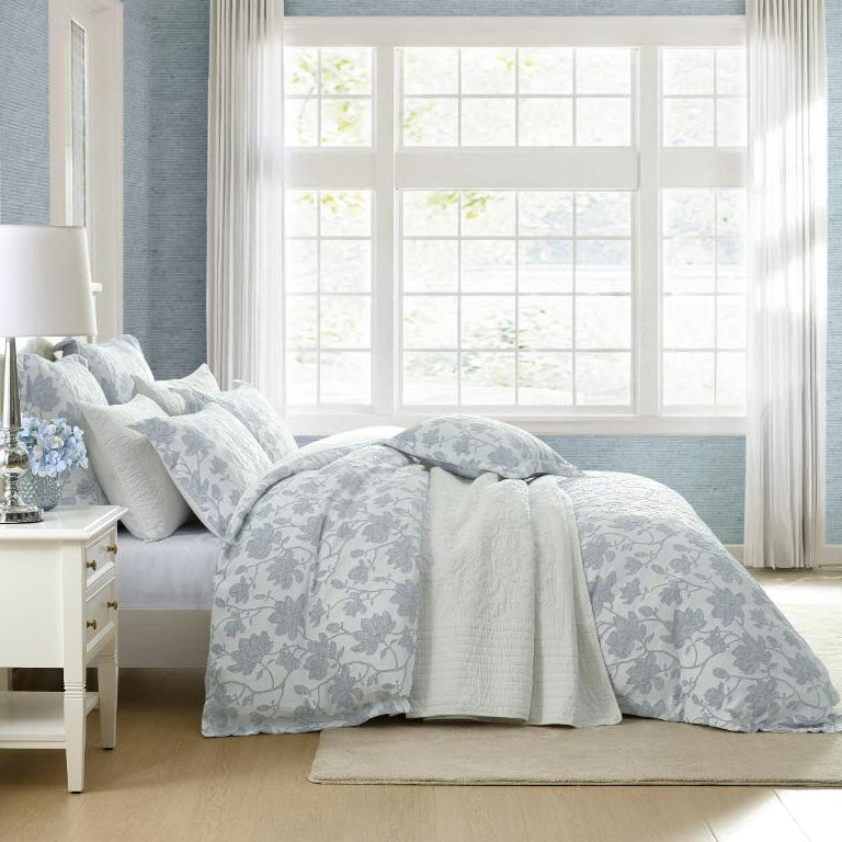 Bedroom with floral bedding and light blue walls