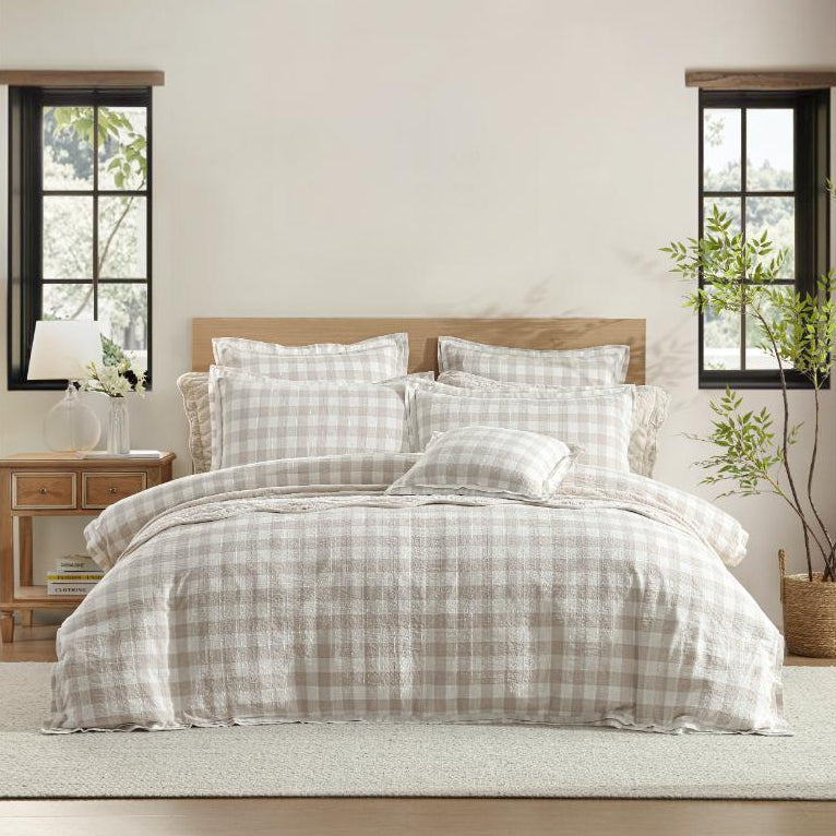 Bedroom with plaid bedding and wooden beams on the ceiling