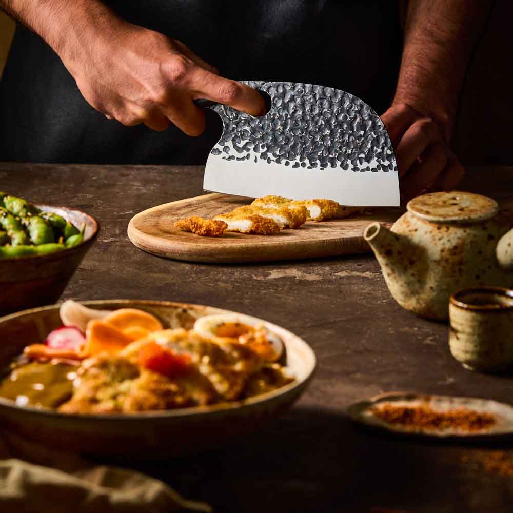 Man slicing katsu chicken with Baccarat KUROI KIBA Moon Knife 17.5cm at MyHouse
