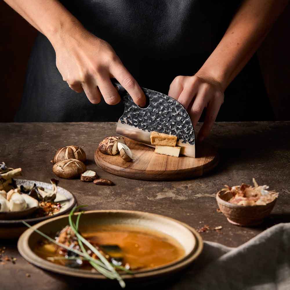 Woman slicing tofu with Baccarat KUROI KIBA Moon Knife 12.5cm at MyHouse