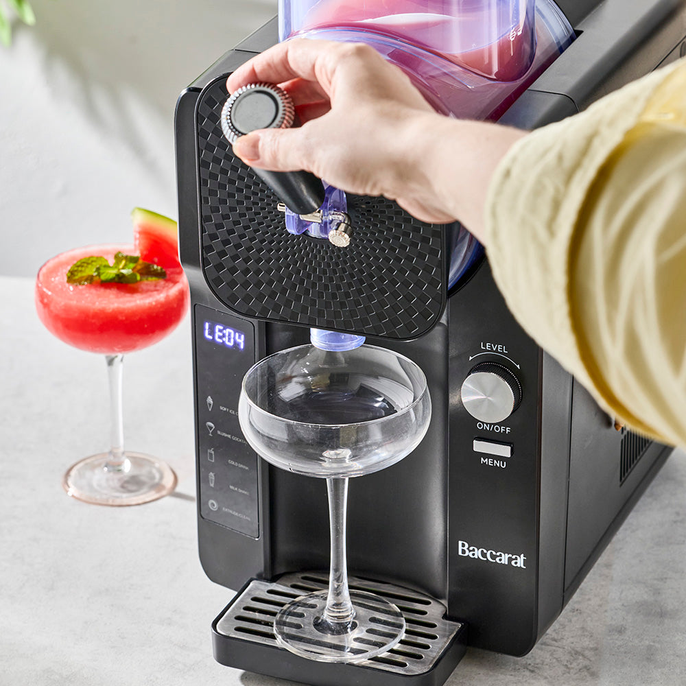 person pouring a slushie from a slushie machine