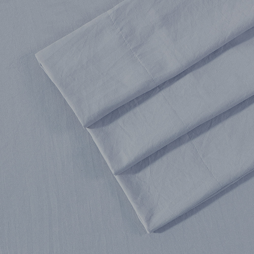 Close-up of Ardor Boudoir Vintage Washed grayish blue sheet set fabric showcasing washed texture and matching pillowcases
