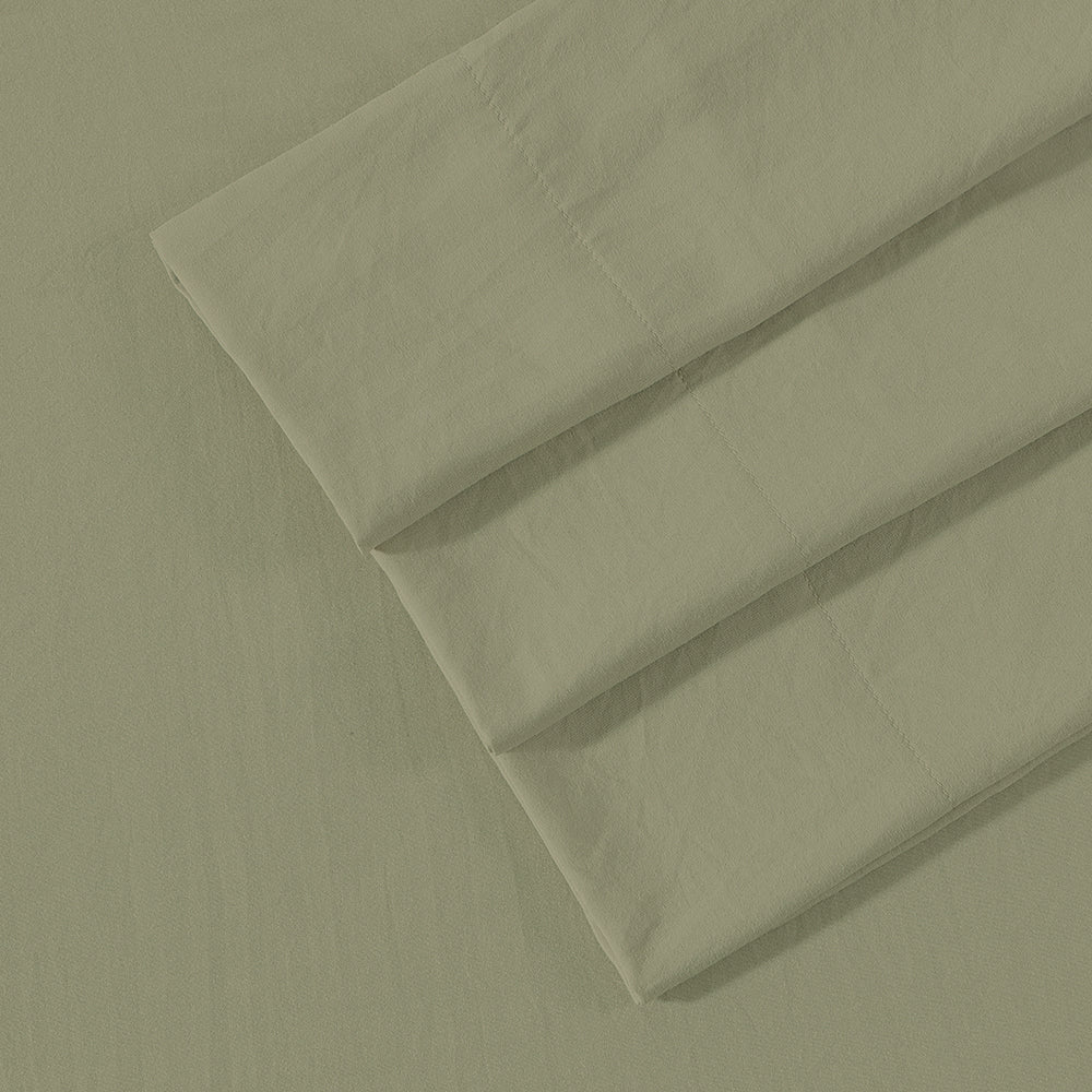 Close-up of Ardor Boudoir Vintage Washed sage green sheet set fabric showcasing washed texture and matching pillowcases