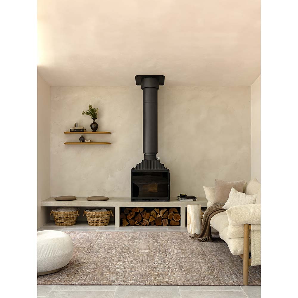 Darren Palmer Moorland Rug in Fig in a lounge setting in front of a fireplace at MyHouse