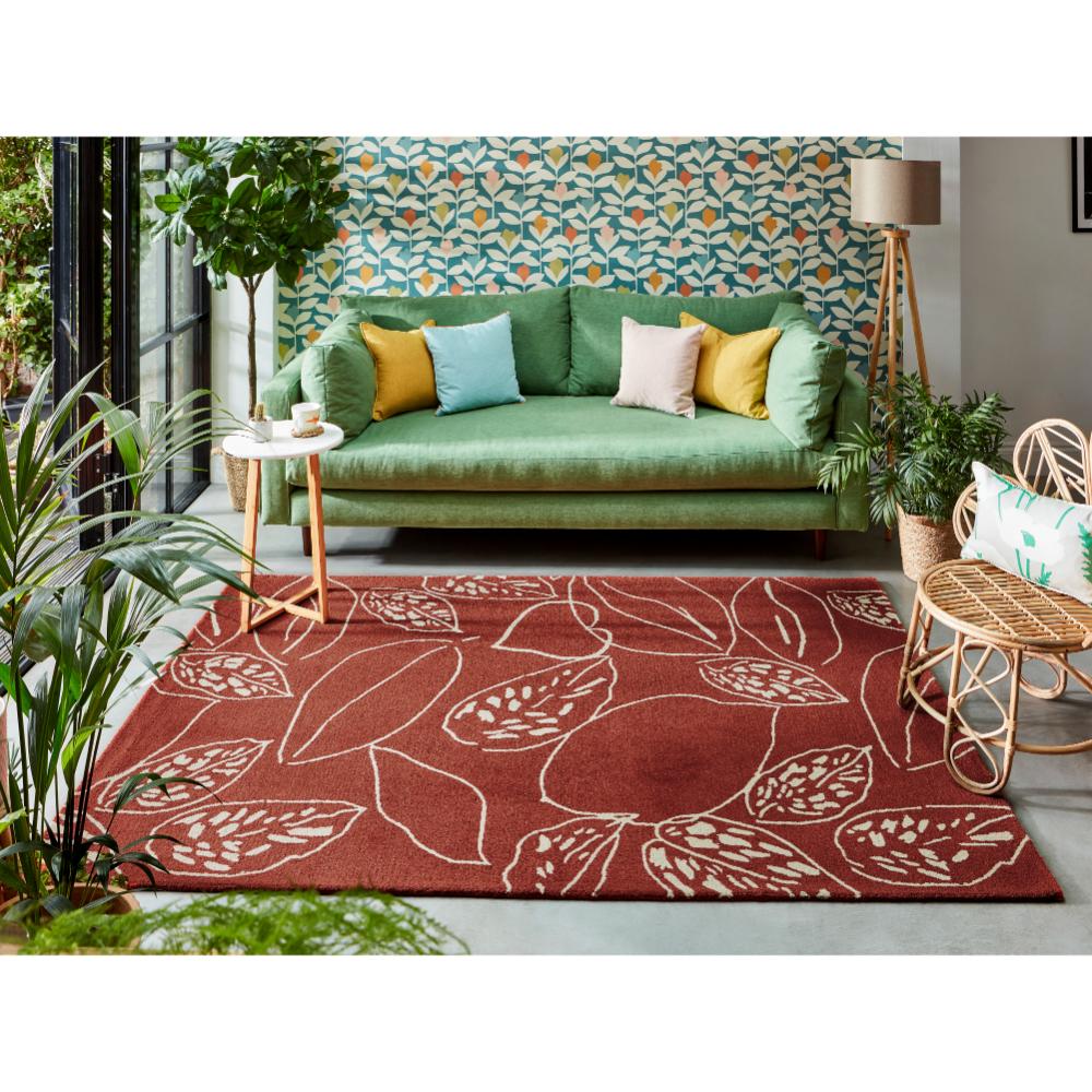 red leaf wool rug with green couch in loungeroom - MyHouse