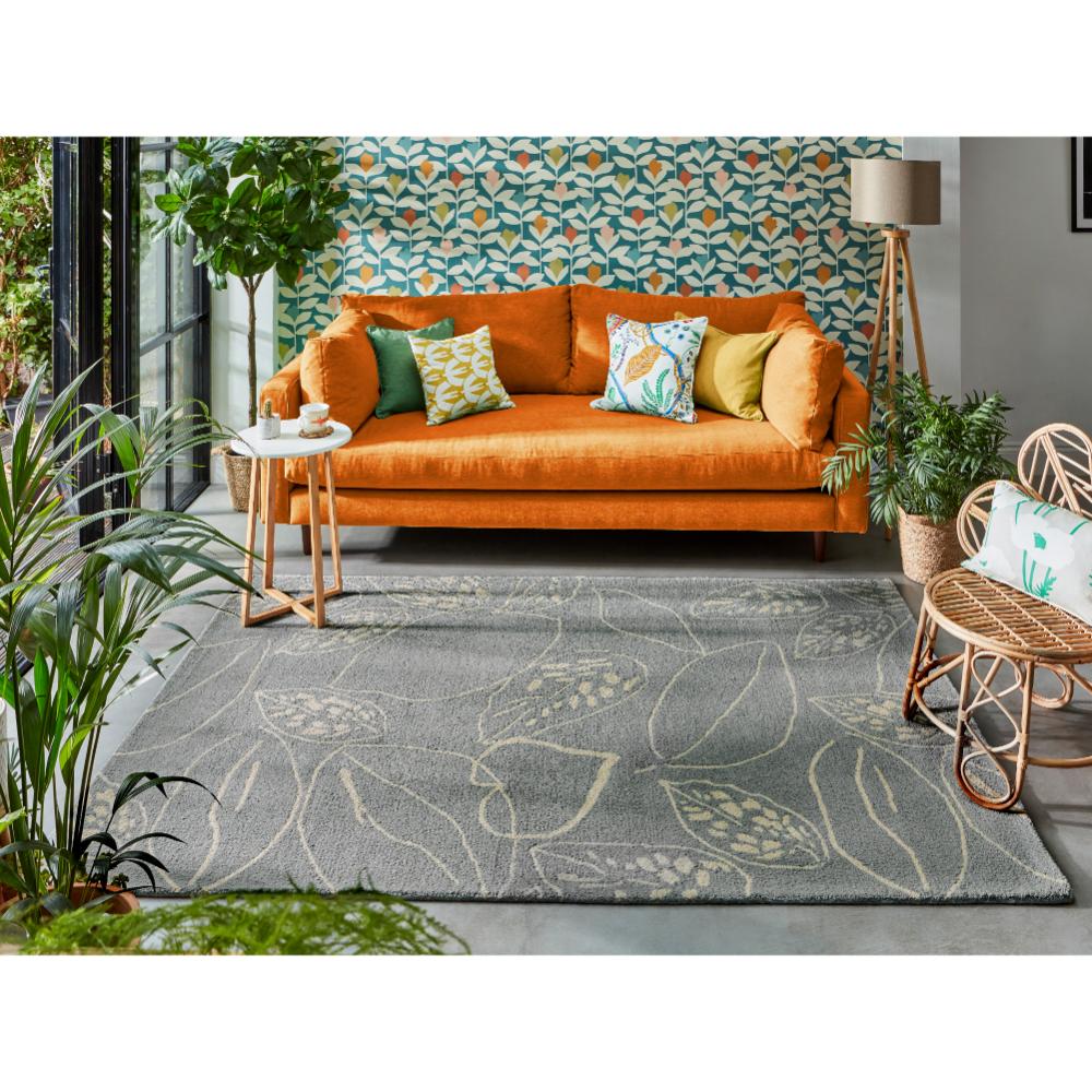 blue leaf wool rug with orange couch in loungeroom - MyHouse