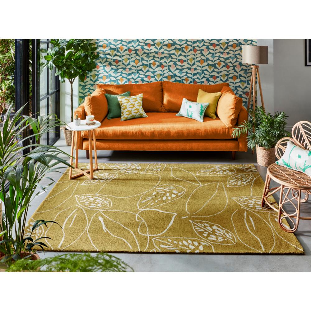 yellow leaf wool rug with orange couch in loungeroom - MyHouse